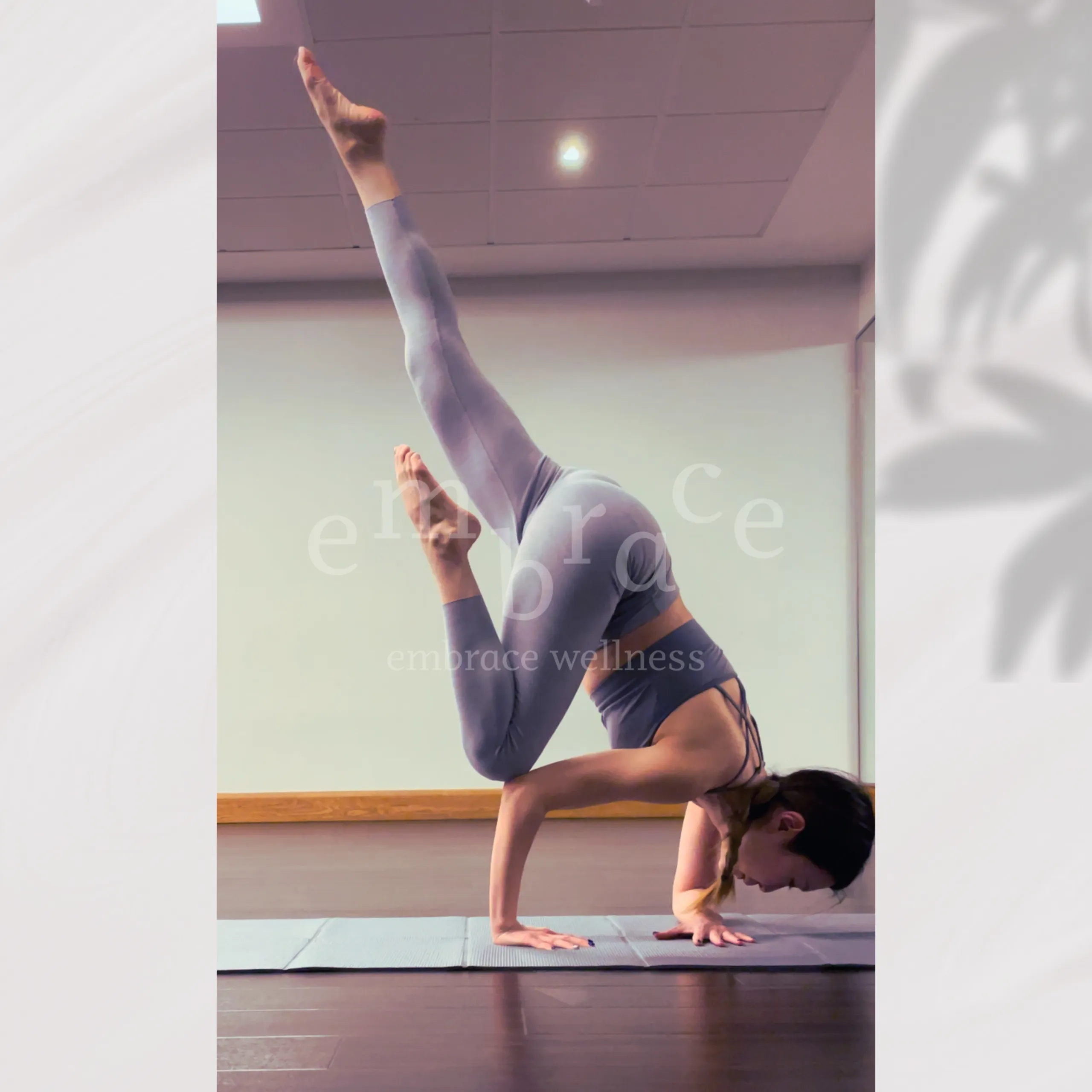 Woman in an advanced inversion yoga pose with one leg extended – Warrior Heart power yoga classes at Embrace Wellness Newbury
