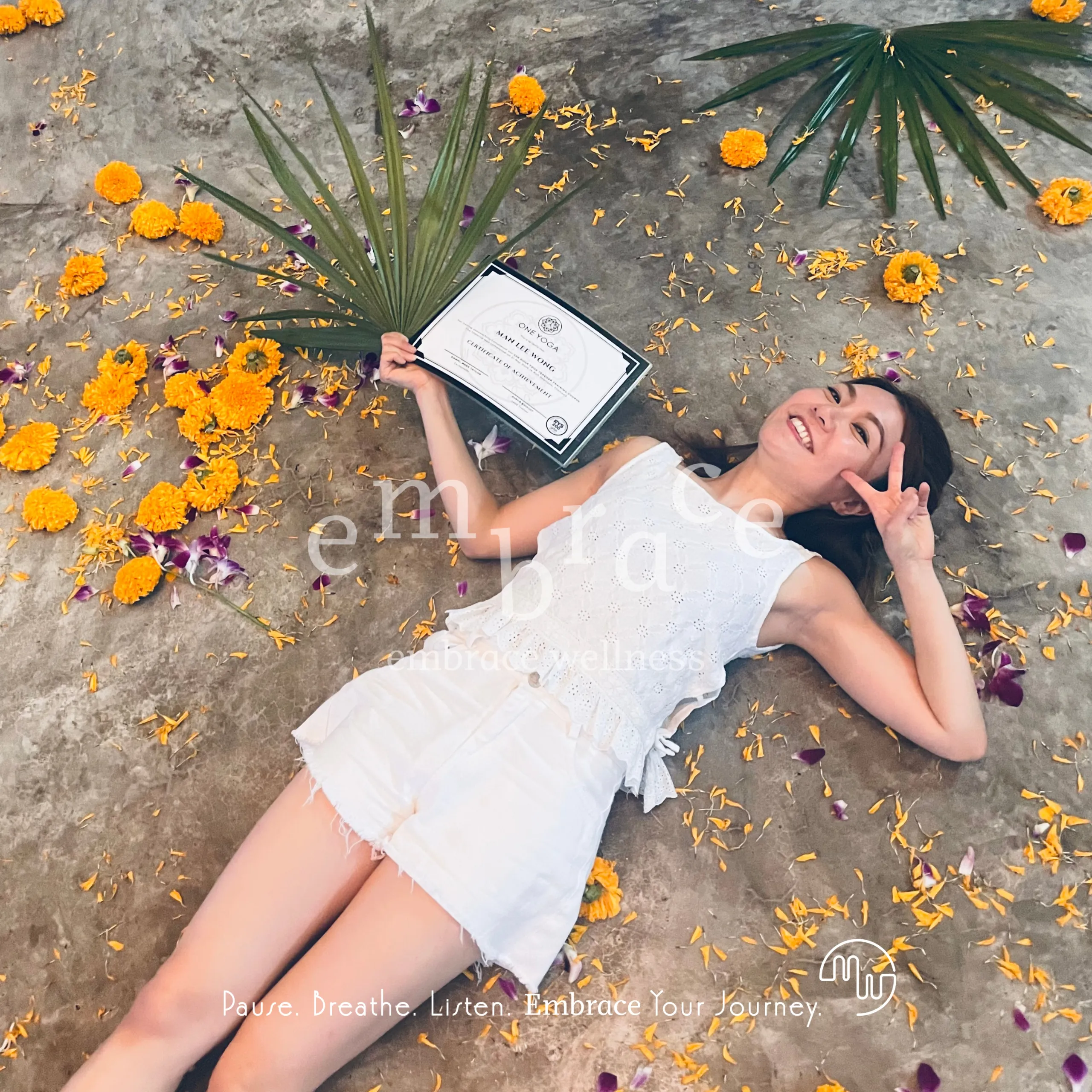 Manlee W celebrating a wellness qualification surrounded by marigold flowers – holistic wellness practitioner and founder of Embrace Wellness Newbury