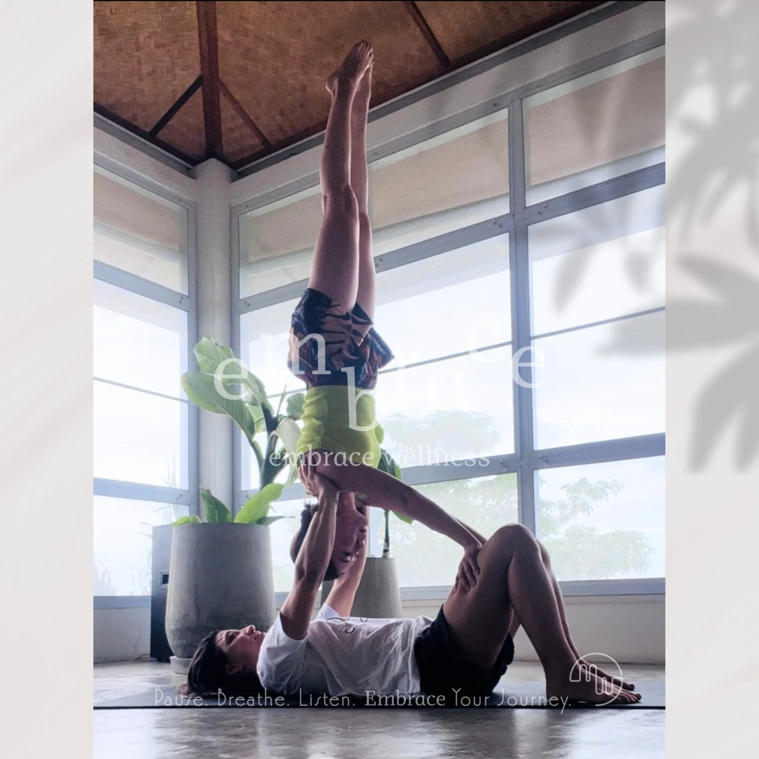Two people practising acro yoga – dynamic and restorative yoga classes at Embrace Wellness Newbury
