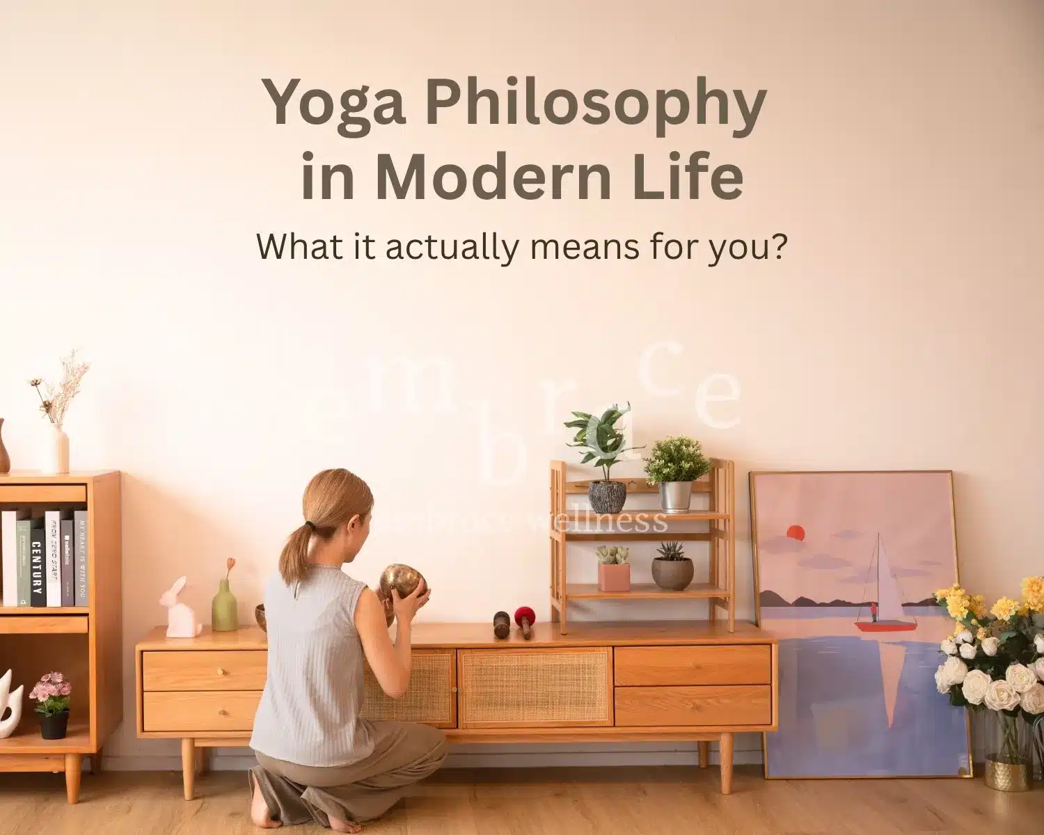 Manlee W, yoga teacher, professional and experiecd sound healer from Newbury, Berkshire, kneeling mindfully with a Tibetan singing bowl in a calm, plant-filled home — Yoga Philosophy in Modern Life with Embrace Wellness