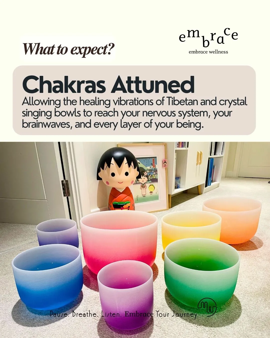 Seven chakra-coloured frosted crystal singing bowls arranged on the floor in a calm, softly lit room, with a Japanese anime figurine and framed artwork in the background. Overlay text reads: "What to Expect? Chakras Attuned — Allowing the healing vibrations of Tibetan and crystal singing bowls to reach your nervous system, your brainwaves, and every layer of your being." Embrace Wellness branding.